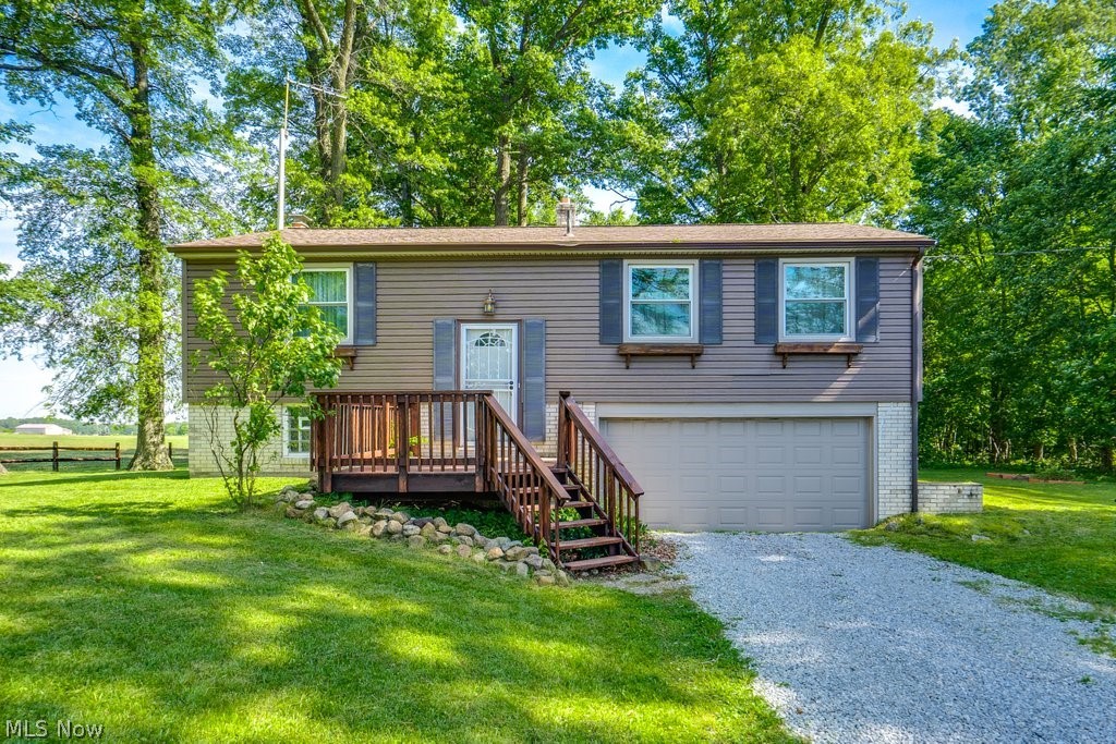 Great opportunity to own a home in the Louisville School District in rural Stark County. This bi-level is just ready and waiting for your personal touch. With three bedrooms and one full bath on the main floor, this is the perfect home for someone starting out, or even for those looking to downsize. The beautiful sunporch off the dining room at the back of the house is a true selling point that offers you pictureque views of the wooded backyard - the perfect place to enjoy your morning cup of coffee or to unwind after a long day. The newly built and stained deck at the front of the home makes it so easy for guests to enter through the front door. Laundry is located in the basement just past the large rec room that would make a great hang out space. Recent updates include: all new septic system, new roof with upgraded shingles, all new triple paned low-E Energy Star Compliant windows, new garage door, new front and storm door, and even more mechanicals to offer you a peace of mind for many years to come. If you're looking for some land with a view and a place to make your own, look no further. Call your favorite Realtor today.