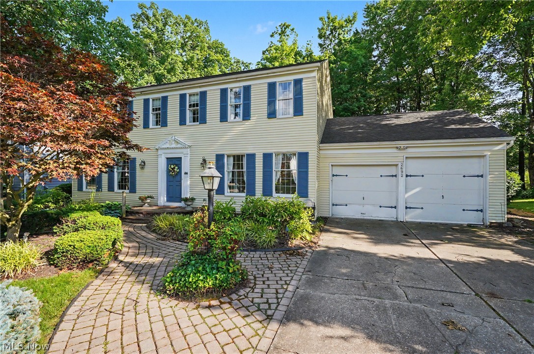 Welcome home to this classic Center Hall Colonial nestled in a beautiful, established neighborhood and lovingly maintained by the same family since 1985. Spacious living and dining rooms provide the perfect setting for everyday living and entertaining. The  kitchen features rich cherry cabinetry, a movable island with breakfast bar extension, and opens seamlessly to the inviting family room complete with a gas fireplace, built-in bookshelves, and crown molding.  French doors lead to a three-season sunroom with access to the brick patio, creating the ideal space for relaxing or entertaining. A convenient mudroom off the oversized two-car garage offers abundant cabinetry for storage or pantry space and even includes a hidden laundry hookup behind the cabinets. A half bath completes the main level.  Upstairs, you'll find a rare five-bedroom layout, each offering generous closet space. The primary suite features a double vanity and walk-in shower with ample closet space.  The second full bath is updated.   The finished lower level provides two separate recreation areas, perfect for a media room, game room, billiards area, home office, or fitness space. Plenty of unfinished storage space remains as well.  Outside, two storage sheds offer exceptional flexibility, with one shed equipped with electricity. Additional highlights include beautiful hardwood floors beneath the carpeting and a home warranty is being offered by the sellers.  Don't wait on this gem.
