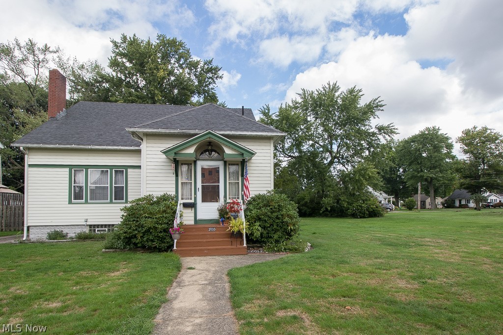 Enjoy the charm of this spacious home with original hard wood floor throughout has large eat in kitchen plus formal dining room, oversize living room, first floor bedroom and full bathroom, 2 bedrooms upstairs with walk in closets and full bath. Spacious 4 season room! Full basement.  Home is on a double lot which provides a nice big yard and room for addition. Great 1.5 car garage w/electric. Sold As-Is.
