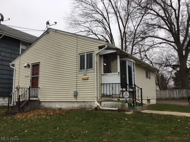 Two bedroom ranch on a nice sized lot with 2+ car garage with shop area!  Hardwood floors in living room, hall and bedrooms.  Large picture window in living room.  Large kitchen has lots of built ins and a bar/ledge opening up to the living room.  Range and refrigerator will stay.  Bathroom has newer vanity and toilet.  Big open basement with high ceilings, ready to be finished.  Working toilet in basement, ready to be walled off.  Washer and dryer stay.  Vented glass block windows throughout basement.  Large paved area in back, perfect for extra parking or use as a patio area.  Huge 2+ car garage with another bay used as a shop with separate electric.  New roof on house 2009, new roof on garage 2007.  Mostly fenced in back yard.  Great starter home or rental property.  Bring your offers!!