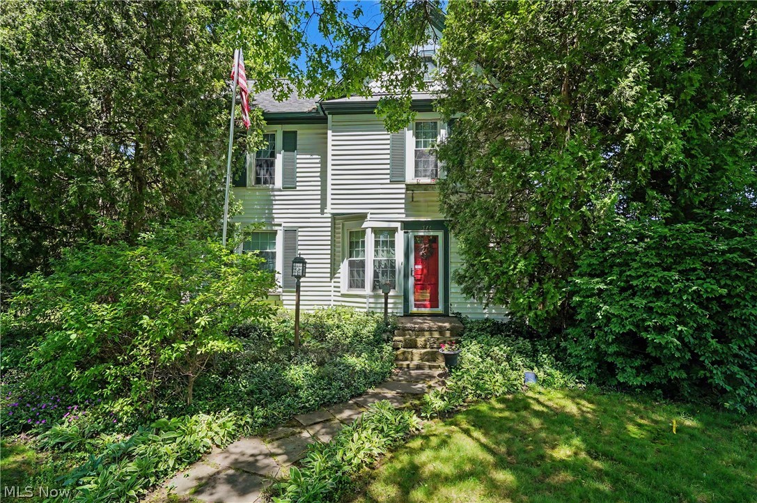 Unbelievable charm on rare .74 acre landscaped, private lot!! This century home has modern updates to compliment the 1845 character that has crown molding throughout, 2 window seats in huge living room plus built-in bookcases, 2 ceiling fans & gas fireplace w/shelves. At one time, half the living room was used as a 6th bedroom, separated by full-length curtains that are still there in case you need them. There's a formal dining room w/built-in china cabinet, chandelier & recessed lighting, closet & french doors to stamped concrete patio w/2 pergolas. There's a 1st floor bedroom between the living rm & dining rm currently set up as an office/sitting room w/closet & full bathroom. Another 1st floor bedroom is currently used as a workshop/studio & has a half bath/closet/laundry room attached. The incredible updated kitchen has island w/3 seats, all white cabinets & appliances & white subway tile backsplash w/decorative tile stripe & piece of inlaid art made by seller! Kitchen includes a glass front cabinet, built-in shelves in wall & island. Back entryway foyer has double closet & ceramic tile floor. Upstairs is magnificent primary bedroom w/wet bar/coffee/fridge/microwave area, cherry/poplar built-in drawers/shelves & trim, walk-in closet, recessed & pendant lighting, 2 ceiling fans & gas fireplace! Two more bedrooms, both w/ceiling fan & built-in shelves are connected by extra sink/counter/dressing area/walk-in closet area. The main bathroom is done in cherry vanity, medicine cabinet, wainscoting & trim w/jetted tub/shower & stone top vanity. Car lovers will appreciate the 3+ car heated garage w/2 7-ft doors & 1 8-ft door in middle, loft, workshop, sink, & heated floors that just need hooked up. Outside you won't believe the beautiful landscaping all around the sandstone back patio & stamped concrete side patio, & stamped concrete walkway to driveway & extra parking, w/partial wood privacy fence along back & one side. It's your own private oasis!