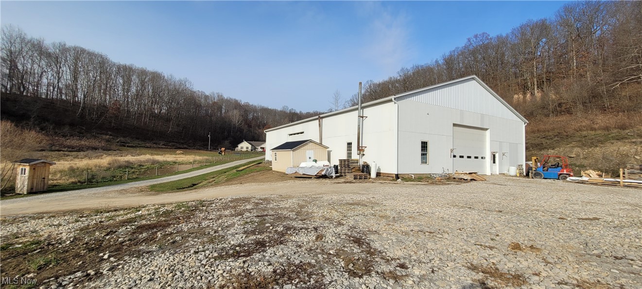 Large shop and acreage for sale in a rapidly growing area near Newcomerstown. Built in 2023 this 60’X96’ shop is complete with concrete floors, 2 large overhead garage doors, insulated garage door panel walls, and a partially finished 18’X48’ living area. Moving outside you will find a nice ½ acre spring fed pond, and approx 4 acres wooded ground, with the remainder being open. Call today for more information. Minerals Transfer.