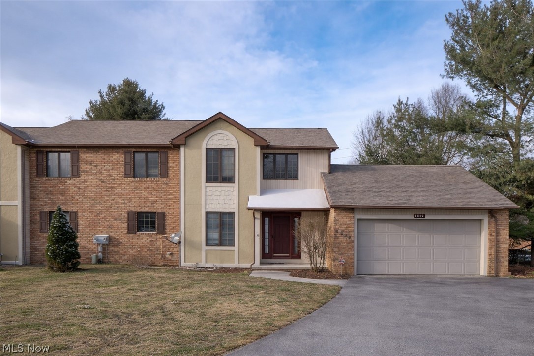 Spacious and well-maintained condo in the desirable Belden Park community of Jackson Township! This 2-bedroom, 1.5-bath home overlooks a pond, offering 1,719 sq ft with soaring vaulted ceilings and a bright, open Great Room featuring a gas fireplace, skylights, and abundant natural light. The Dining Room, currently used as a recreation space, opens to a sunroom/office with French doors and serene pond views. The fully applianced eat-in kitchen boasts granite countertops, ceramic tile flooring, ample cabinetry, and a dinette area. Convenient first-floor laundry and half bath. Upstairs features a small loft/landing with balcony overlooking the Great Room, a spacious primary bedroom with walk-in closet and pond views, and a second bedroom with a shared full bath. Full unfinished basement with glass block windows provides excellent storage or future finishing potential. Attached 2-car garage with extended driveway and new concrete added in 2025. Quiet cul-de-sac location with easy access to shopping, dining, and amenities. HOA includes maintenance for low-stress living. A must-see!