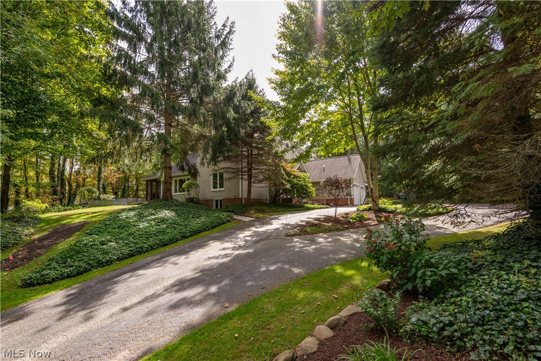 An amazing home in the center of Auburn! A must see custom built home located in a cul-de-sac on 1.5 acres. The main floor is all hardwood floors, featuring a beautiful kitchen with cherry cabinets and granite countertops. Just off the kitchen is a nice dining area and living room with fireplace. Enjoy a relaxing dinner on the screened in outdoor porch. Upstairs is the master suite with vanity bath and walk in closet. Just off that is a nice loft area and two additional bedrooms with full bath. The lower level is finished with a rec room/ bar area and a separate unfinished area with a second staircase up to the garage. Recent updates include hot water tank, well pressure tank, concrete walkway, windows, doors and more! A truly beautiful home!