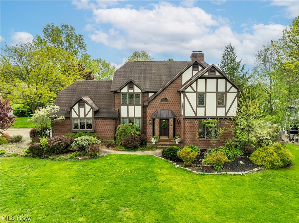Stately Tudor-inspired brick home situated on a beautifully landscaped lot with timeless curb appeal in desirable Foxchase Hills. Featuring distinctive architectural details including steeply pitched rooflines, decorative half-timber accents, and classic diamond paned windows, this residence offers a warm blend of character and sophistication. Upon entry of the home you are immediately greeted by the open, turned staircase and 15 ft ceilings. Oak harwood floors flow through the first level and complement the cherry crown molding that's found throughout the main areas of the home. The front living room has recently been updated with new carpet and paint. The hallways, dining room and 4th bedroom/office and kitchen have also been repainted. The open kitchen is warm and inviting with cherry cabinetry, Cambria quartz counters, new lighting, new cabinet hardware and Stainless steel applainces. Off of the kitchen a passthrough bar connects to the great room featuring a sloped 19 ft ceiling with sky light and stone floor to ceiling fireplace. Upstairs are 3 well situated bedrooms with walk- in closets. Off the 3rd bedrom is an additional large storage closet for extra household needs. The 2nd full bathroom is a split design featuring the shower area and vanity separate from the watercloset and another vanity. The master has a classic cherry wood style gas fireplace and spacious ensuite with pitched ceiling and skylights, double sinks with new faucets and vanity lighting, shower and seperate jetted soaking tub and was recently freshly painted. Downstairs the basement is fully finished with 2 rec areas and feautures a pool table that stays and a kitchenette/bar area with granite counters. Outside is more room for entertaining with a 2 teir trex deck, gazebo and koi pond with a waterfall and patio area. This home is truly one of a kind and ready for it's new owners! Agent owned.