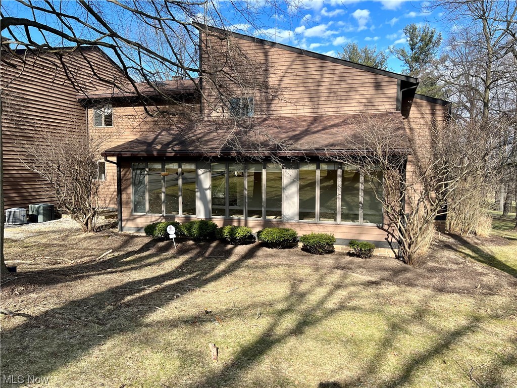 Wow! This desirable condo has views of hole #16 of the beautiful Lake Club and views of Evans Lake. The showcase stopper of this home is the enormous vaulted sunroom full of light with views of both the 15th and 16th fairways. The dining rm is off the sunroom and features a black & white marble tile floor. The living rm has a deck and mirrors along the backwall so you can see the golf course. A big eat-in area right off the kitchen w/ views of the golf course opens to a huge granite island in the kitchen. This island features  a sink, cupboards & a small drink fridge. This unique kitchen has the stovetop, 2 wall ovens & a sink in an alcove at the back of the kitchen. Off the kitchen is a 1st fl laundry room w/ a Bosch front loading washer & dryer. Double doors open to a 1st fl office w/ sliders to a deck that overlooks the condo grounds w/ a glimpse to the 17th tee. There is a half bath on the 1st fl.On the second fl. a spacious master has a large walk-in closet & sliders to another de