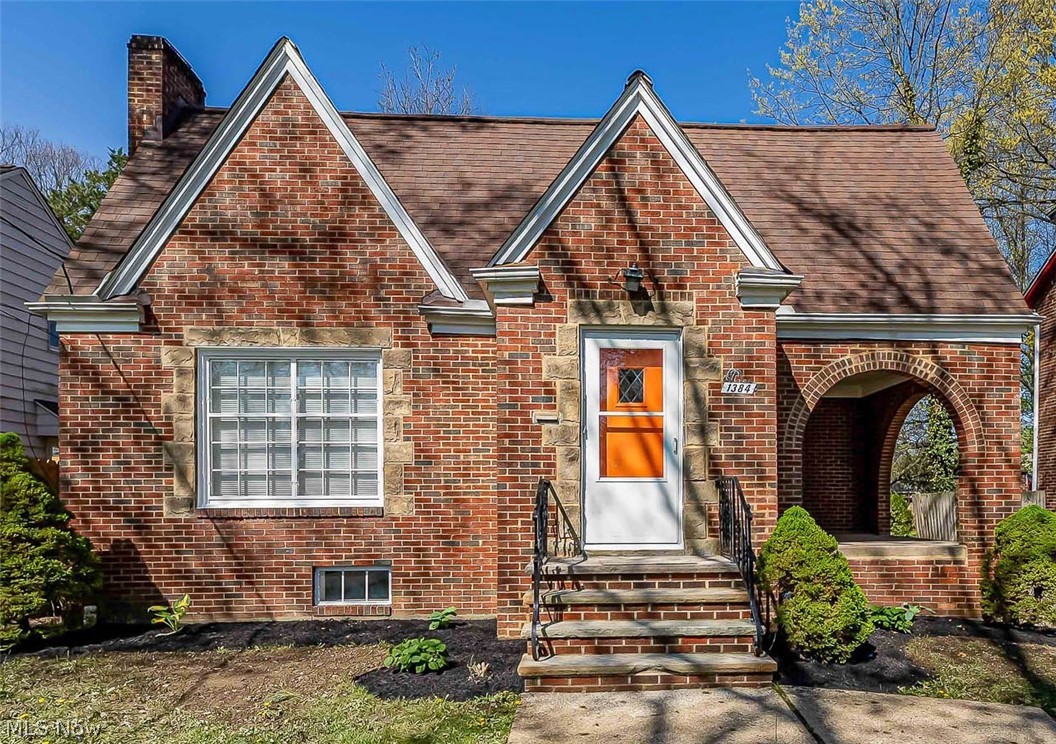 Welcome to 1384 Argonne Rd in South Euclid—a beautifully updated Cape Cod that perfectly blends timeless character with modern updates, while offering far more space than meets the eye. ***Check out the 360 Degree Panoramic Virtual Tour and Floorplans!*** This home is truly deceiving in size, delivering expansive rooms throughout and unique features that make it stand out from the rest. Step inside to a bright and spacious living room with hardwood floors and a fireplace, flowing seamlessly into the dining room with classic built-ins. Just off the living room, enjoy a covered porch highlighted by unique brick arches that add incredible charm and character. The updated kitchen features granite countertops, an abundance of stylish cabinets, sleek finishes, and stainless steel appliances. Two generously sized bedrooms and an updated full bath complete the main level. Upstairs, the expansive primary suite offers a private retreat with vaulted ceilings, a walk-in closet, an additional updated full bath, and a large bonus space ideal for a home office, lounge, or flex area. What truly sets this home apart is the hidden lower-level space. A concealed area tucked behind a sliding bookshelf reveals a one-of-a-kind speakeasy-style retreat complete with another fireplace and bar area—perfect for entertaining or unwinding in your own private hideaway. An half bath, laundry area, and an abundance of space for storage or additional recreation space complete the lower level. With a deep backyard, and a layout that offers significantly more space than it appears from the outside, this home is packed with character, functionality, and surprise features you won’t find anywhere else. Home Warranty Included! Schedule your private showing today!