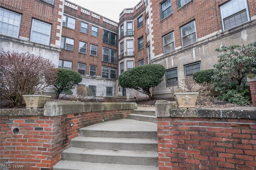 Exceptional location and opportunity. Wonderful 1 bedroom condo in a historic building. Walking distance to Little Italy, Case Western Reserve University campus, University Hospital, Cleveland Clinic, the Rapid Transit System and all that University Circle has to offer!!! All furnishings and furniture are negotiable. Neutral decor throughout, this meticulously well maintained property boasts; spacious rooms, 9 ft ceilings, gleaming hardwood floors, gorgeous crown molding and loads of natural sunlight. Formal dining room. Large living room with a beautiful gas fireplace. Kitchen with ample cabinet/counter space - all appliances stay. Sprawling master. Convenient in suite laundry - stacked washer and dryer stay. Central Air installed 2010. Renovated shower 2018. Covered parking. Home Warranty. Water, sewer and gas included in the HOA fee. Access to Doan Brook ravine is a short walk to the end of Ambleside - you can hike or mountain bike all the way to shaker Lakes and beyond - Mother Nat