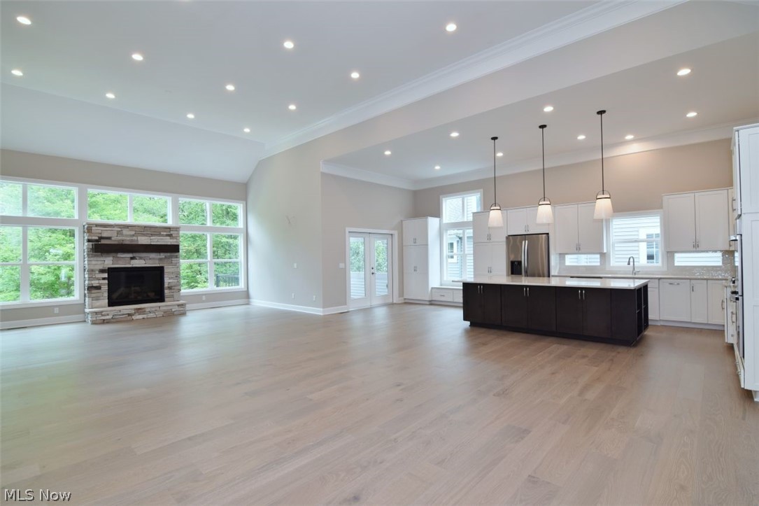 Discover sophisticated comfort at 7994 Canyon Ridge, a stunning 3-bedroom, 3-bathroom newly built home in Chagrin Falls designed for effortless first-floor living.  ORIGINALLY  constructed by long time home builder Miller Homes as builder's own home.  The bright, open layout features engineered hardwoods throughout the main living spaces and a spectacular chef’s kitchen equipped with quartz countertops, a premium double-sided storage island, gas cook top, drawer microwave, double ovens and high-end stainless steel appliances. The primary suite serves as a private spa oasis, complete with heated floors, steam shower and a zero-entrance shower, and a massive walk-in closet. The huge great room features a fireplace in the center of a wall of windows and is set up for an entertainment center and dry bar. Downstairs, an expansive windowed basement is ready for your custome design details. Step outside to your private sanctuary: a screened-in porch with a composite deck leads to a concrete patio, all overlooking sweeping, serene views of the surrounding woods, ravine, and river. Built for maximum efficiency, the home features a two-speed Trane high-efficiency furnace, a tankless water heater, and an insulated garage pre-plumbed for gas heat. Bonus: The purchase price includes a landscaping and closet shelving allowance, offering the perfect opportunity to customize your dream space from day one.