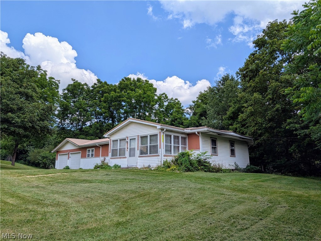 This slice of heaven is waiting for you to make it your own.  Enjoy country living, close to all the amenities in Calcutta, situated in Beaver Local School District, with easy access to Rte 11 and Rte 7.  The stove, refrigerator, hot water tank and front windows are newer.  An Amish metal roof was installed in 2024.  There is another room with a closet that can be used as a fourth bedroom.  The basement is dry.  There is a sump pump, but it is used for AC and washer.  There is also a gas well on the rear of property that can be tapped.  Well and septic inspection done and passed.