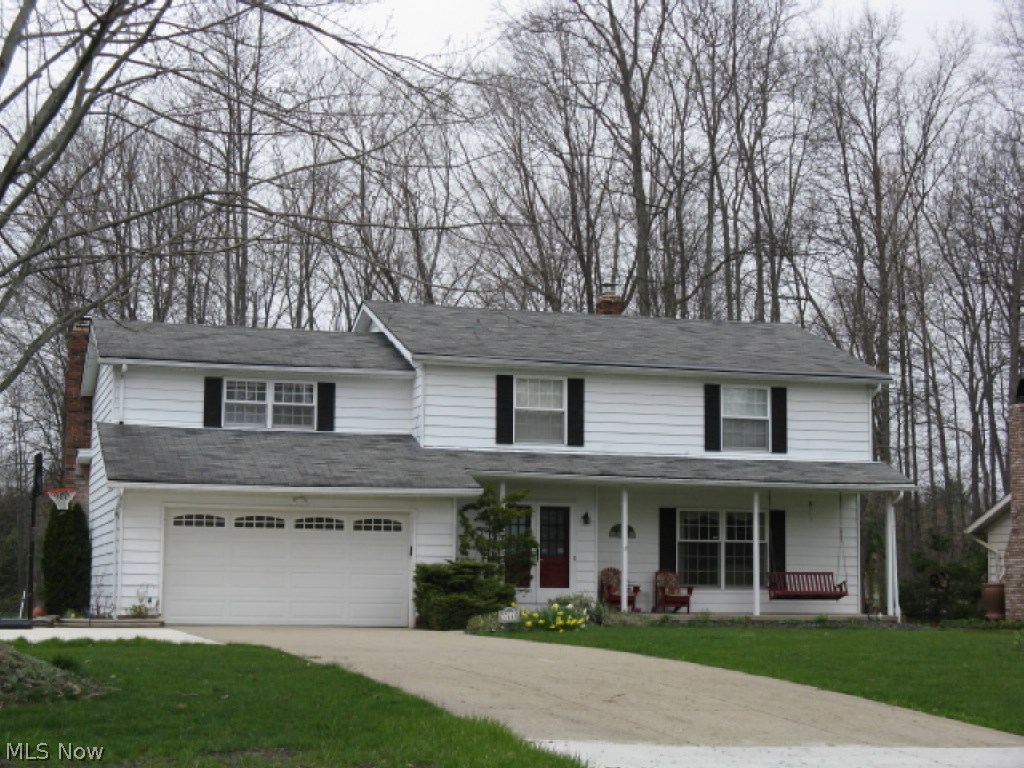 This 4 bedroom, 3.5 bath colonial in north Solon's Colonial Estates is move in ready.  A full front covered porch, enhanced by professional landscaping, greets your guests in comfort and style.  The large foyer features black slate flooring and leads to the living room, half bath & kitchen.  The large living room is open to the family sized dining room w/elegant chair rail detail.  You will love cooking in the remodeled kitchen featuring cherry cabinetry, granite counters, glass tile backsplash and breakfast bar overlooking the eating area.  The step down family room offers a full brick fireplace and slider to the back deck.  Upstairs you find a large master suite with remodeled spa-style bath and large walk-in closet, 3 additional generously sized bedrooms, and the large family bath and the laundry area.  The finished basement offers a rec room pre-wired for entertainment audio, office/bonus room, full bath, pantry closet and large storage/mechanical room.  The huge deck overlooks the