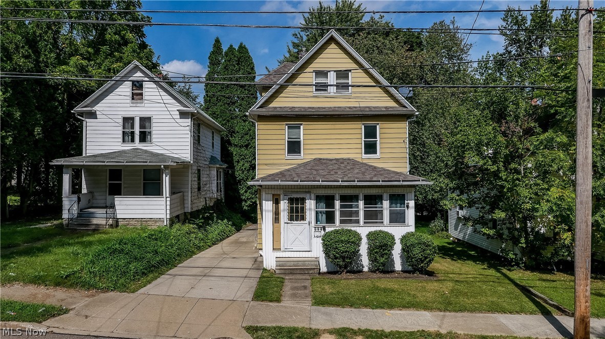 421 E. Thornton St, Akron, Ohio 44311 is a 3 or 4 bedroom home with a newly renovated bath, fresh paint, ready to go with plenty of parking! 1st floor consists of a front  enclosed Sunporch, large Living Room with built-in shelving, Dining Room with Window Seat and corner Cabinet, Kitchen with plenty of cabinetry and gas stove and rear door to private parking. 2nd floor has 3 rooms plus the large remodeled bathroom with updated vanity, light, mirror, cabinet shelf unit and linen closet. 3rd Floor has a huge bedroom with double closet and the basement level has Laundry hookups. Roof only 9 years old, water tank only 1 year, furnace 10 years old. The home has been utilized as a rental home with a great historical rental record of 4 bedrooms @ $450 each and $950 plus utilities. Seller just remodeled the bathroom and freshened the paint and added laundry. There is a large parking area out back and the private drive is a bonus (NOT shared). The basement foundation wall was replaced previous