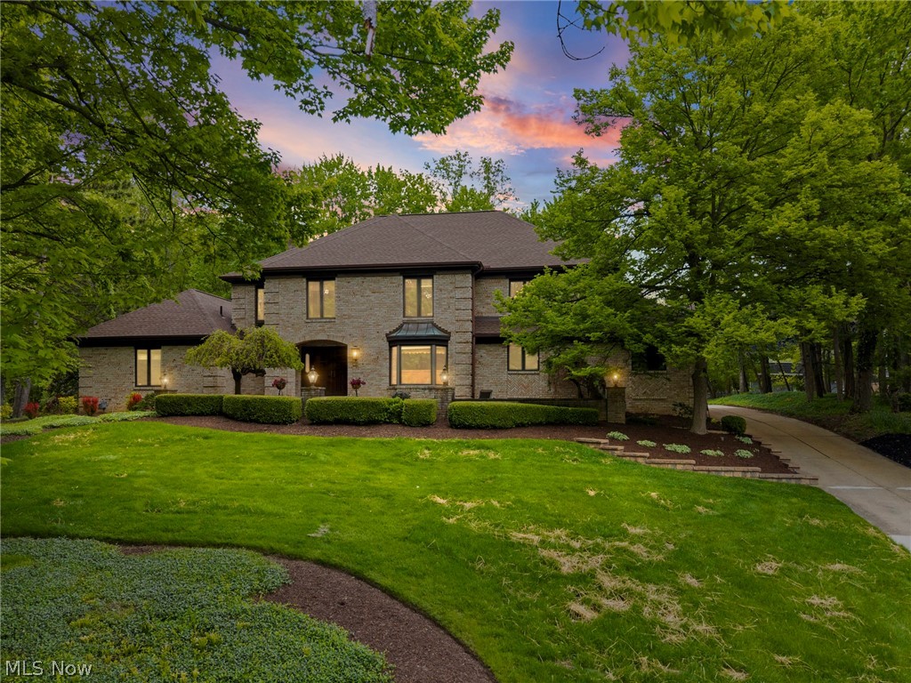 Welcome to this elegant brick French-style home perfectly positioned on a majestic hilltop setting offering timeless architecture, exceptional quality, and luxurious living throughout. Showing like new, this stunning residence blends sophisticated design with warm inviting spaces ideal for both everyday living and entertaining.

The dramatic two-story Great Room showcases a soaring stone fireplace and private entertaining bar perfect for morning coffee or evening gatherings, all flowing seamlessly to the open loft above creating an additional relaxing retreat. The beautifully updated kitchen features granite countertops, redesigned butler’s pantry, and exceptional functionality for hosting family and guests alike.

The luxurious first-floor owner’s suite is a private sanctuary complete with fireplace, vaulted wood ceiling, cedar walk-in closet, and spa-inspired bath featuring a jetted tub, double sinks, skylight, granite counters, and chic designer tile finishes. Sliding doors open directly to the spacious deck overlooking the breathtaking park-like grounds.

Outside, enjoy a professionally landscaped backyard with custom gazebo, welcoming trellis, paver patio, and winding private paths creating a peaceful retreat setting. A richly paneled first-floor office offers flexibility for a home office or additional bedroom.

Upstairs features an open loft, two spacious bedrooms with generous closets, newer carpeting, and an upscale full bath. The expansive lower level offers endless possibilities for recreation, fitness, playroom space, or abundant storage.

Additional updates include newer dual HVAC systems, upscale tankless hot water heater, and newer roof for added peace of mind. Enjoy neighborhood amenities including a private pool while being only minutes from Metroparks, shopping, dining, the Turnpike, and major freeways.