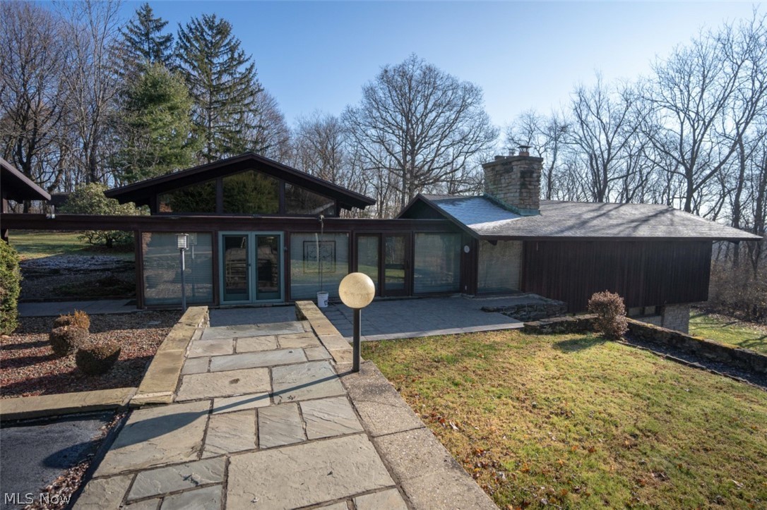 This one-of-a-kind award winning home, formerly known as the Porter House, awaits your viewing. The tri-nuclear house plan allows each function of the home its own wing with the kitchen and dining room nestled in the middle. It is an open floor plan permitting access quickly to each part of the house. The major walkways are laid with beautiful flag stone and each wing has large exquisite free standing stone fireplaces.  You will not be disappointed with the workmanship of the wood interior and glass panels that view out on the property. Each floor has its own access to the outside with sliding doors and a wrap around deck off the living room. This house features 3 full baths, sauna, whirlpool bath and an office which can easily be converted to a 3rd bedroom with a loft above. The one acre of ground this house sits on is wooded on two sides and has two sheds located on it. The large carport has room for multiple vehicles with a storage tool room. All thermopane windows have been replaced in the last 10 years.