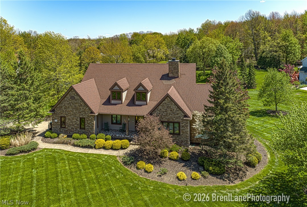 Spectacular contemporary home on premium cul-de-sac lot in the Broadview Heights Creekside Reserve. 5 bedroom, 3.5 baths, over 6000 sq.ft., includes In-law/teen suite. 2-story foyer has hardwood floor. To the left is formal dining room with trayed ceiling. To the right through French doors is formal living room with gas log fireplace and built-ins. Straight ahead is the great room with 2.5-story wall of windows overlooking huge pond, ceiling to floor stone gas log fireplace, wet bar w/granite top and fridge. Off the great room is the generous sized eat-in kitchen with walk-in pantry, granite countertops, center island, newer high-end appliances, and a bay window with picturesque views. Ceramic tile floor leads to Morning room with slider to massive deck. Further off the foyer is the hallway to the master suite with more views, glamour bath with Jacuzzi tub, shower, and large walk-in closet with built-ins. Completing main level is half bath, first floor laundry room, access to heated garage with utility sink, floor drain, and electric opener. Also off the foyer is stairway to second level which has three bedrooms and a full bath.
Enormous walkout lower level has In-law/teen suite which includes: kitchen with island breakfast bar, ceramic tile floor, combination living room/dining room with slider to patio, and double doors to bedroom with views. Off the kitchen is full bath with seated shower. The tour continues through double doors to the game room/rec room and large furnace room with plenty of storage. Completing lower level is the theater room and office/possible 6th bedroom.
Elegant stone front has covered porch with ceramic tile floor. Finally, a meticulously landscaped yard with accent lighting.
Immediate occupancy. America's Preferred one year home warranty included. A must see!