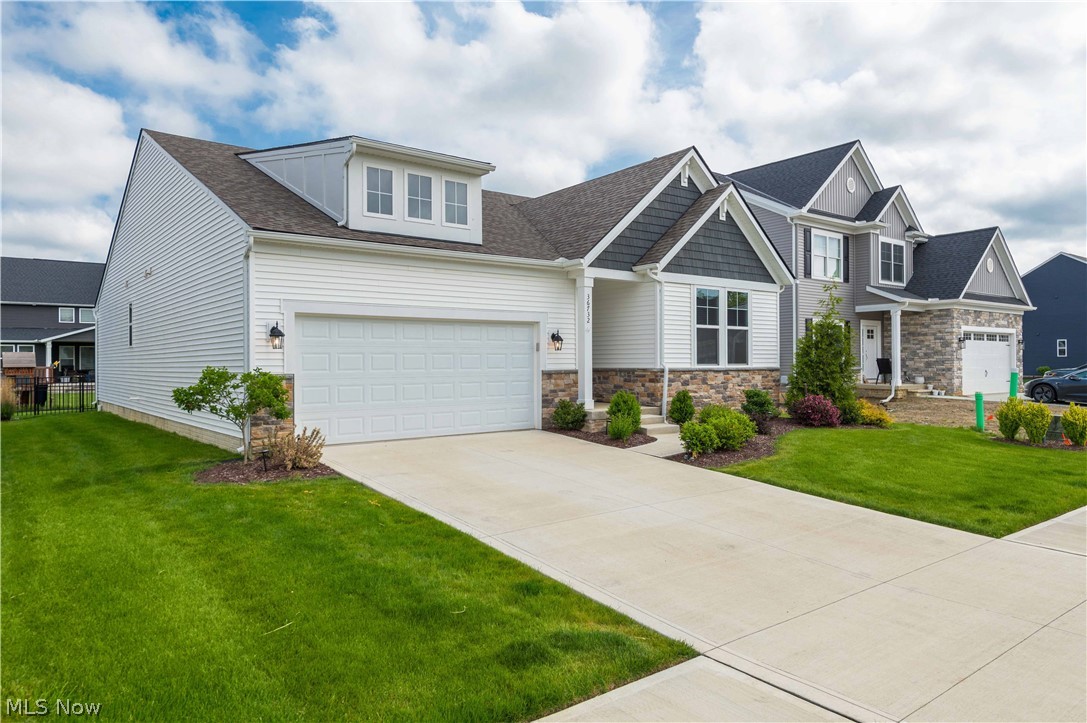 This nearly-new ranch in North Ridge Point offers the perfect blend of modern design, functional living, and outdoor enjoyment — all in a community featuring a pool, playground, and tennis courts. Built just 2 years ago, this 3-bedroom, 2 full bath home showcases an open-concept layout with vaulted ceilings, recessed lighting, luxury vinyl flooring, and an abundance of natural light throughout.

The spacious kitchen is the centerpiece of the home featuring white shaker cabinetry, quartz countertops, subway tile backsplash, stainless steel appliances, a large center island with seating, pantry, and seamless flow into the dining and living areas complete with a cozy gas fireplace.

The private owner’s suite offers a spacious bedroom, oversized walk-in closet, and beautifully finished en-suite bath with dual vanities and a walk-in shower. Additional highlights include a convenient mudroom/laundry area, full basement offering endless finishing potential and storage, and a sprinkler system to keep the lawn looking pristine all season long.

Step outside to one of the home’s standout features — the covered back porch and extended paver patio creating an exceptional outdoor living space perfect for relaxing, entertaining, or enjoying summer evenings. The fully fenced backyard with wrought iron fencing provides both style and functionality while maintaining an open feel to the beautifully maintained yard.

Why wait to build when you can move right into a like-new home with upgrades already completed? Located in desirable North Ridge Point with resort-style neighborhood amenities and easy access to shopping, dining, and highways.