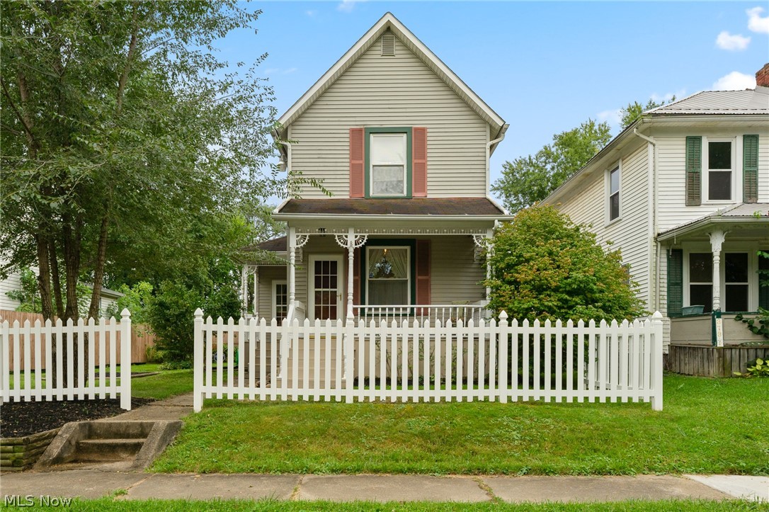 Move right into this three bedroom century home just minutes from local parks, schools, and dining. Enjoy sitting out on your covered front porch on those soon to be perfect fall evenings, and when it gets too hot- hang out inside and stay cool with the central air. Large spacious eat in kitchen, large living room, first floor bedroom and two large bedrooms upstairs. First floor bathroom. No need to worry about taking your laundry down to the basement- first floor laundry just off of the kitchen. Additional plus is the oversized 2 car garage with carport or additional covered patio area.
