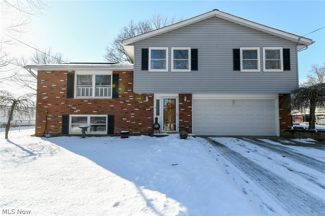 Beautiful house in Tallmadge neighborhood!  Welcoming foyer with space for personal decorations, double closet, adorable half bath. Walk up the split staircase to a bright, spacious living room continuing into the remodeled kitchen and dining area.  The wall was removed showing off the gorgeous custom-made cabinets with soft close hinges, quartz countertops, stainless farmhouse sink, hands-free faucet, high-end appliances, and an island!  Every fixture, finish, and detail has been perfected!  New sliding door draws you into the amazing sunroom built in 2019 and the warranty transfers!  Enjoy this space with comfortable furniture, television, and your private backyard.  Living room leads upstairs displaying a sliding barn door, four nice-sized bedrooms with gorgeous new carpet, and an incredible full bathroom updated with tub surround, toilet, vanity, vinyl, and large linen closet in hallway.  The master bedroom features double closets with new doors.  The lower level begs for casual re