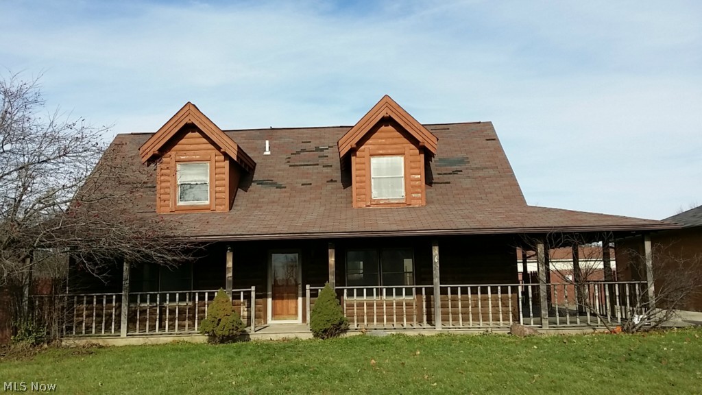 A large log home with a nice wrap around porch. Has a nice 2 car garage and above ground pool