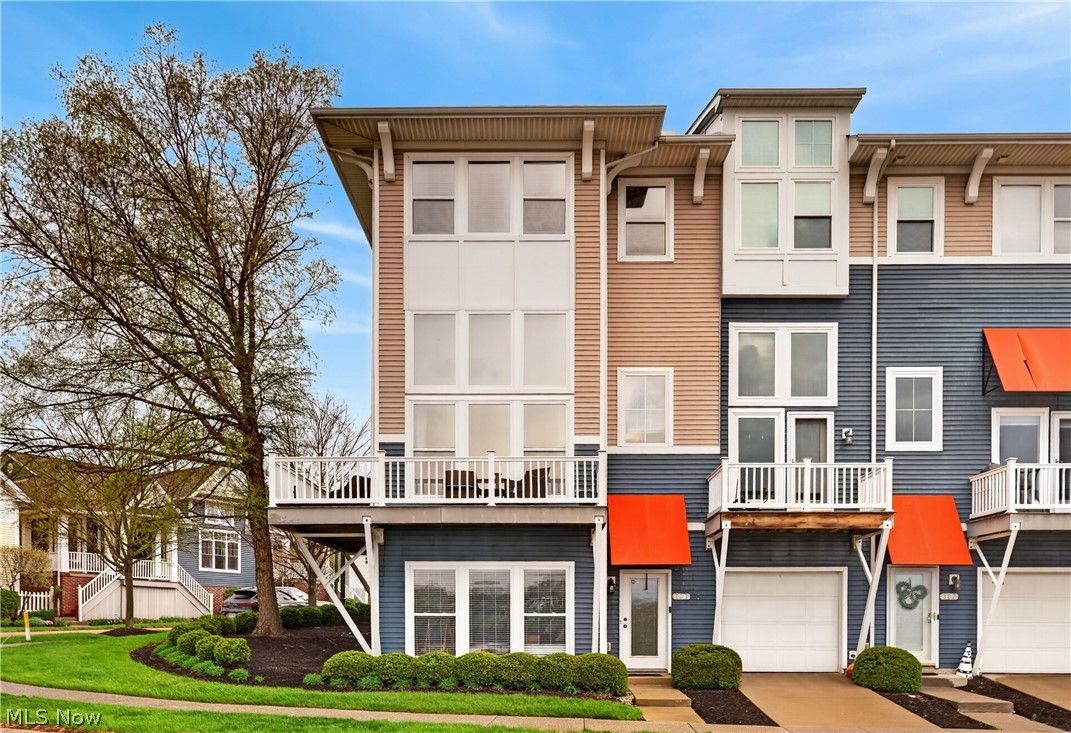 Experience elevated waterfront living in this stunning end-unit townhome located in the highly desirable Harborwalk community. Offering over 2,400 square feet of thoughtfully designed living space, this home showcases beautiful views of the Black River, breathtaking sunsets, and the iconic Charles Berry Bascule Bridge—all just across the street from Lake Erie. Step inside to a bright and welcoming entry-level family room featuring ceramic tile flooring and abundant natural light. The main living level offers an open-concept layout designed for both everyday living and entertaining, highlighted by floor-to-ceiling tinted windows that fill the space with sunlight. Custom motorized shades add both convenience and style, while the gas fireplace creates a warm and inviting focal point. Step out onto the private wrap around deck off the living room—perfect for enjoying morning coffee or evening sunsets and listening to the music across the river. The kitchen is beautifully appointed with granite countertops, custom cabinetry, a built-in buffet with wine storage, center island, stainless steel appliances, and ceramic tile flooring. Balconies at both the front and rear of the home make it easy to enjoy the outdoor setting from multiple vantage points. Upstairs, the spacious primary suite offers a true retreat with room for a king-sized bed, sitting area, walk-in closet, and luxurious four-piece bath. Two additional bedrooms,  full glamour bath, and a convenient laundry room complete the upper level. Additional features include a 2 car attached garage &  access to Harborwalk’s exceptional amenities, including  pool, fitness center & event space. Just moments away, enjoy the newly enhanced stage at Black River Landing—perfect for concerts, events & summer nights along the water. Recent updates include  new roof (2023), ceiling fans (2023), motorized shades (2018), and buffet cabinet (2017). Enjoy the best of waterfront community living—schedule your private showing today.