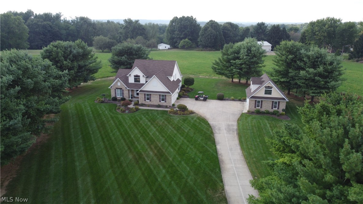 Free yourself from the subdivision trap. Picture you and your family secluded on four plus acres of land with easy access to the amenities of the City of Green or the shopping at Belden Village. Your new home has been meticulously maintained and awaits your belongings. Impressive two story foyer with overlooking loft area. Formal dinning room or eat in kitchen to meet your culinary pleasure. Spacious Master Bedroom with a four piece en suite and walk in closet.  Privacy for the kids or guests in two second floor bedrooms. Great potential for additional finished lower level with a 12 course basement. Take the party outside to the covered deck complete with cable television ability. Attached two car garage for safety and security adjacent to first floor laundry featuring a dirty man shower. Detached two car garage with the man cave framed above. Sellers are willing to connect sewer and water rough plumbing.  Fantastic potential for additional income. Automatic sprinkler system. Call now.