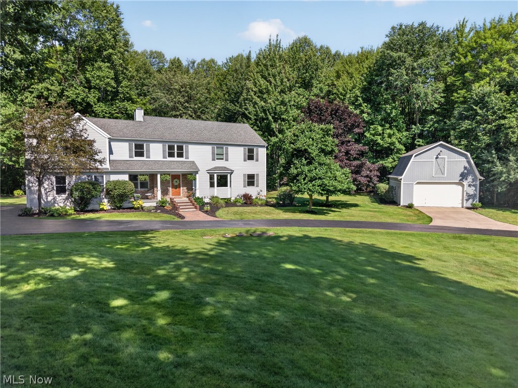 Beautifully updated Colonial tucked away on over 2 private wooded acres on a cul-de-sac street in Chardon Twp, w/ over $175K in improvements completed by current owners. Set back behind a stocked pond w/ fountain & dock, the property offers a peaceful setting complete w/ a 32' x 24' barn, deck, patio, gathering area w/ pergola, shed & side-entry 2-car attached garage. Located in the Chardon School District, this home offers 4 bedrooms, 3.5 baths & over 3,470 living sq ft including a finished walkout basement. The open-concept main level includes an updated eat-in kitchen w/ all stainless appliances, granite countertops, large center island w/ breakfast bar, tile backsplash, abundant cabinetry & deck access. The vaulted great room features a stone fireplace & expansive windows overlooking the wooded backyard, while the dining area offers a tray ceiling & bay window. A dedicated 1st-floor office & mud room w/ storage cubbies complete the main level. Upstairs, a loft overlooks the great room while the primary suite features a private balcony, walk-in closet & en-suite bath w/ dual vanity, jetted soaking tub & separate walk-in shower. A 2nd-floor addition includes a lounge/study area leading to 2 bedrooms w/ large walk-in closet. Spacious 2nd-fl laundry room plus additional hookups in the basement. The finished walkout lower level offers a large rec room w/ wet bar & patio access, 4th bedroom, full bath & bonus room ideal for a playroom, office or home gym. Additional highlights include 4-zone heating & 2 sump pumps. Some UPDATES: Roof (2013), HVAC (2011), HVAC zone system (2013), water softener (approx 2020), 2nd-fl addition (2013), kitchen remodel (2017), 2nd-fl bath remodel (2024), driveway culvert (2019), gas fireplace conversion (2017) & much more. Detailed update list available upon request. INCLUDED: ALL kitchen appliances, washer/dryer, basement fridge & freezer, pergola, all TVs except great room, window treatments, mud room cubbies, 1-yr home warranty.