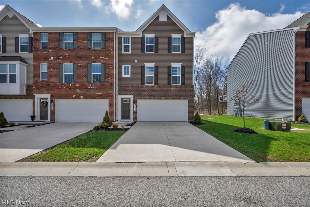 Welcome to refined, low-maintenance living in the highly desirable Brookside Crossings community. This end-unit townhome offers an elevated lifestyle with added square footage across all three levels and an abundance of windows that fill the home with natural light, creating a bright and expansive atmosphere throughout. As the largest floor plan offered by the builder, you'll notice the difference from the moment you enter.
The kitchen is a true statement in modern design, featuring black stainless steel appliances, custom black cabinetry, under-cabinet lighting, a striking white quartz island with seating, and a natural stone backsplash. The open-concept main level, complemented by 9-foot ceilings and additional living room windows, creates a bright, airy space ideal for both everyday living and entertaining.
Upstairs, the owner's suite offers a comfortable and private retreat with a spacious walk-in closet, while the convenience of upper-level laundry enhances functionality. The finished lower level adds valuable living space and is complete with a stylish wet bar, making it the perfect setting for recreation, relaxation, or hosting guests.
Outdoor living is equally impressive, with a premium TimberTech composite deck extending from the kitchen and a walkout lower level leading to a stamped concrete patio. Thoughtfully added downspouts help keep the patio area dry during rainy weather, enhancing the usability of this outdoor space year-round. Backing to a peaceful nature reserve, the backyard offers exceptional privacy and serene wooded views rarely found in townhome living.
Complete with a two-car garage, this move-in ready home delivers modern style, thoughtful design, and luxury finishes at an approachable price point—all while being conveniently located near shopping, dining, and everyday amenities.