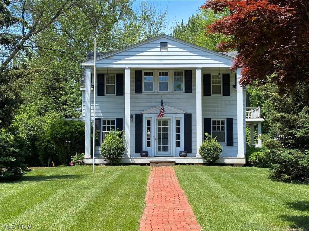 EXCLUSIVE country AND lake living in this grand 2 story colonial in Timberlake. Not only will you have private lake access, but you are minutes from shopping, Route 2 and 90. A live fence along the Lakeshore Blvd side of the property maintains the peace and tranquility you will find here. A large paved turn around driveway with detached 2 car garage makes coming and going a breeze. A huge front and side yard with mature trees and a brick walkway up to the front door which is flanked by columns. A main floor bedroom with a half bath, and 3 more large bedrooms upstairs with a full bathroom provide space and privacy. The main floor screams functionality as you can enter the kitchen from multiple doorways. The partially finished basement has a fireplace and bar as well as a half bath, that can be easily made into a full bathroom. The utility room contains the laundry and a walkout to the rear of the home. Visualize the potential as you tour this home and notice the large moulding and histo