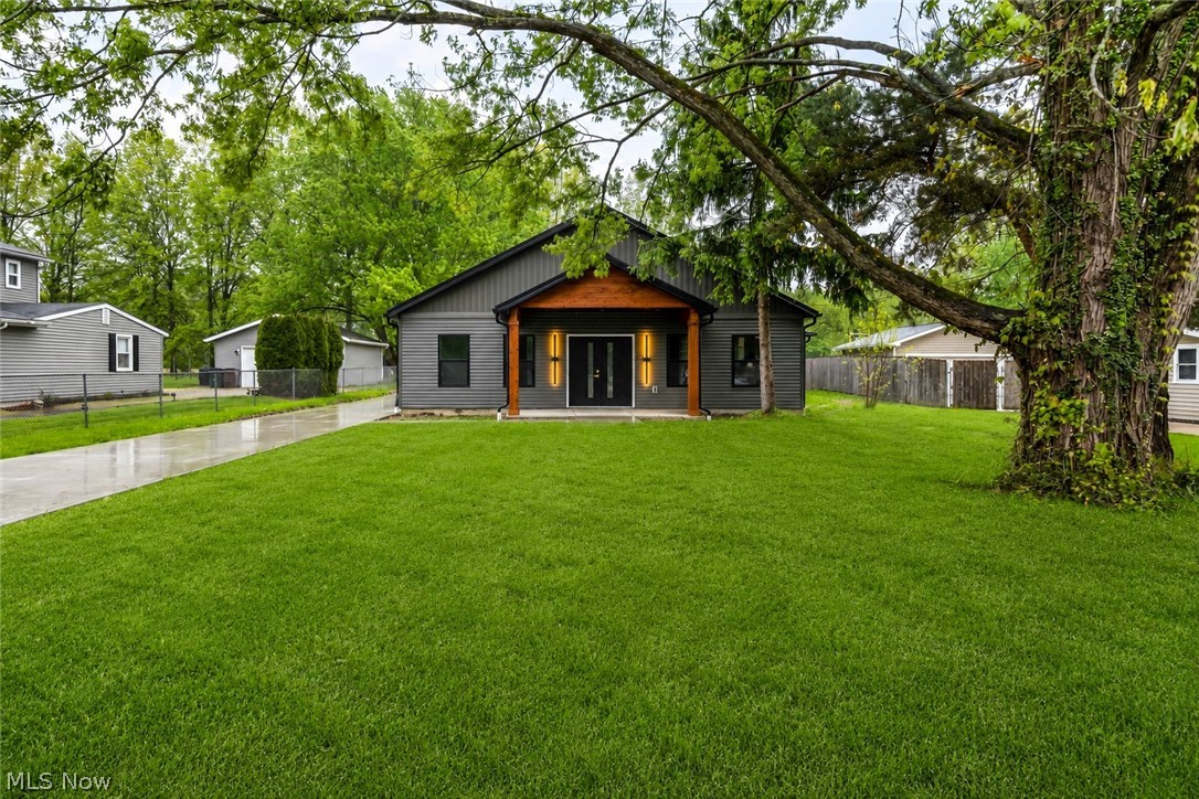 NEW CONSTRUCTION, JUST COMPLETED – Modern Ranch on a Private Half-Acre Setting. Welcome to refined one-floor living in this thoughtfully designed 2,152 sq ft new-construction ranch, perfectly set back on nearly half an acre for privacy and tranquility. This home blends modern farmhouse style with high-end craftsmanship, offering both function and timeless appeal. Featuring 4 bedrooms and 2.5 bathrooms, this slab-on-grade home is built with 2x6 construction and upgraded insulation, delivering superior energy efficiency and durability. A striking metal roof and board-and-batten front elevation create immediate curb appeal, complemented by black windows and a dramatic 72” double entry door with 80” height clearance. Inside, the open-concept layout is highlighted by vaulted ceilings in both the great room and dining area, creating an airy, light-filled living space ideal for entertaining. The eat-in kitchen is equipped with brand-new appliances, quartz countertops, and sleek finishes that balance elegance with everyday usability. The private primary suite is a true retreat, featuring a spa-inspired bath with double vanity, water closet, walk-in shower, and a stunning 60” freestanding soaking tub. Throughout the home you’ll find luxury vinyl plank flooring, solid-core 8’ interior doors, custom wood closets, and matte black fixtures for a cohesive, modern aesthetic. Additional highlights include: Oversized 2-car garage with 8’ garage door, Tankless hot water system, Slab foundation for easy, accessible living, Premium finishes and attention to detail throughout. This exceptional new build offers privacy, efficiency, and elevated design—just minutes from town conveniences while surrounded by open space. A rare opportunity to own a brand-new, move-in-ready ranch in Columbia Station.
Still under construction—secure now and watch your dream home come to life.