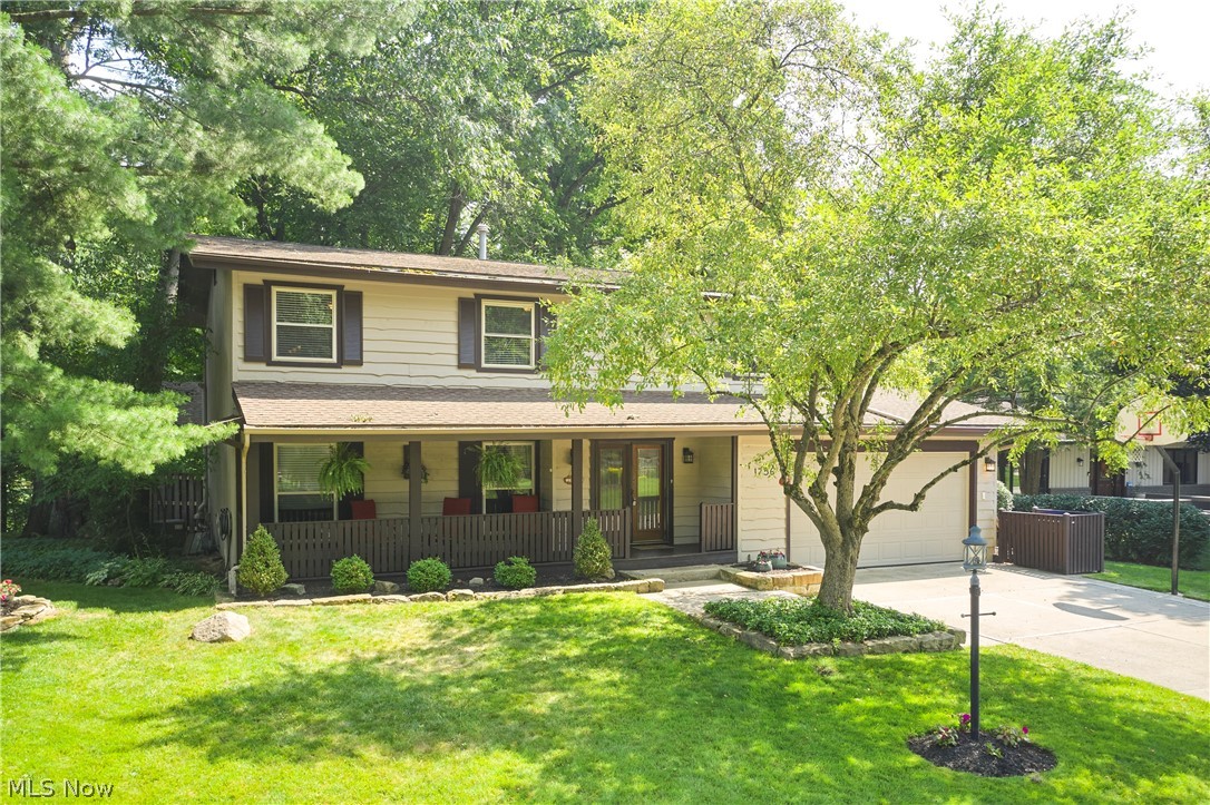 Welcome to this tastefully updated 4-bedroom, 3.5-bath Colonial nestled in the highly desirable Towpath Village neighborhood and served by award-winning Revere Local Schools. The beautifully updated kitchen opens seamlessly to the inviting Great room with fireplace, creating the perfect space for everyday living and entertaining. A stunning sunroom overlooks the private backyard retreat featuring a timber pergola, stamped concrete patio, firepit, deck, and peaceful wooded views. Formal living and dining rooms add timeless elegance to the main level.  Beautiful oak wood floors throughout the main level. Upstairs, the spacious primary suite offers a private slider to an elevated deck overlooking the serene backyard, while three additional bedrooms, a full bath, and conveniently located second-floor laundry complete the level. The finished lower level adds over 500 square feet of additional living space with a large rec room and full bath. Enjoy relaxing mornings on the expansive covered front porch, plus the convenience of a 2-car attached garage. Towpath Village residents enjoy outstanding amenities, including a community pool, clubhouse, tennis and pickleball courts. Ideally located just minutes from Cuyahoga Valley National Park, the Towpath Trail, Szalay's Farm & Market, Blossom Music Center, and all that this area has to offer. A rare opportunity in one of Northeast Ohio's most sought-after communities!
