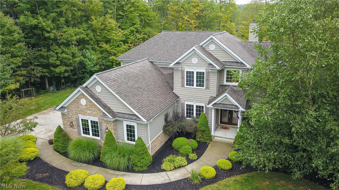 Welcome to Paradise! This incredible 2006 custom-built home has it all! The tastefully landscaped lot offers multiple entertaining areas as well as a 16' x 32' Kayak pool which overlooks the private, wooded 6.46 acre parcel. The interior of the home features high ceilings, custom cabinetry and stone counters. The kitchen opens to a spacious two-story great room with exquisite trim, a wall of windows and a gorgeous fireplace. First floor master suite, dining room, laundry/mud room as well as a guest bath round out the main level. The second floor has three additional bedrooms and two full baths. If required, the second floor bonus room could easily be converted to a 5th bedroom. A recently finished walk-out basement lends itself to entertaining with the bar area, an additional full bath and exercise room with access to an exterior pet kennel. Plenty of dedicated storage areas in this home. An oversized 24' x 31' 3+ car garage. No detail forgotten and no expense spared. This lot is approved to have horses via the HOA.