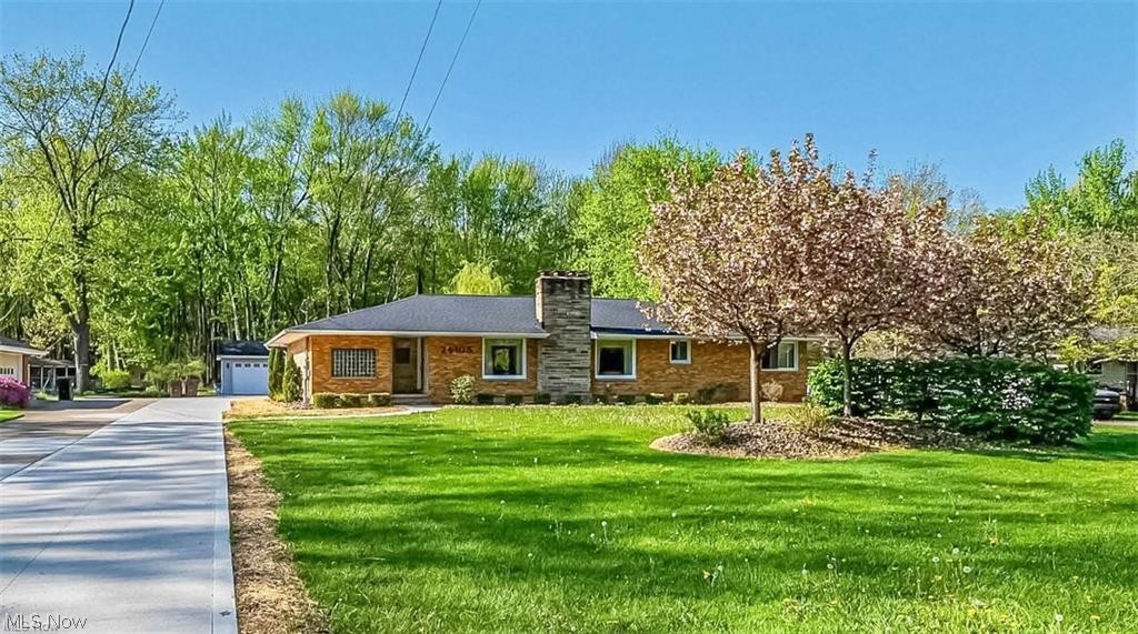 Rare 2.2-acre property with private wooded backdrop in Westlake, located in the highly rated Westlake City School District. This fully renovated ranch offers 3,169 sq ft of bright, open living space with one-floor convenience and a finished lower level. Ideally located near I-480, I-90, shopping, dining, and Crocker Park. Renovated in 2019, updates include electrical, plumbing, roof, HVAC, tankless hot water, smart thermostat, 200-amp service, garage subpanel, and EV charging station. The open main level connects the kitchen, dining, living, and great room with a stone fireplace and large picture windows overlooking the landscaped front yard. The kitchen features granite surfaces, a 10-foot island with 5-burner cooktop, built-in convection and speed ovens, wet bar, and dishwasher. Additional highlights include a powder room, first-floor laundry, and bright sunroom/mudroom. The primary suite offers a walk-in closet and private bath, with additional spacious bedrooms. The finished lower level includes a theater with 4K projector and screen, game room, office/flex space, and second wet bar. Unfinished space offers excellent storage, walk-in pantry, workshop, new windows, and completed waterproofing. Set back on a deep lot extending into scenic woods, the property offers rare privacy, open green space, and a mature weeping willow tree. South-facing rear exposure provides abundant natural light. Outdoor living includes a large deck, custom grilling station, outdoor TV, and patio dining area. A 3-car garage, 20x10 storage shed, and newly completed driveway complete this exceptional home. Upgraded warranty offered with property through APHW for 1 year.