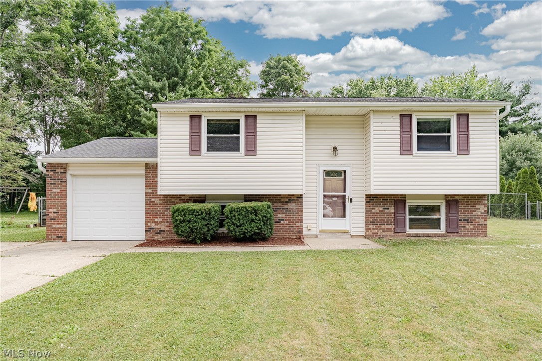 Welcome to 4988 Commanche Trl, a charming bi-level home in the heart of Stow! This home offers spacious living areas, a flexible floor plan, and a generous backyard designed for relaxing and entertaining. A welcoming foyer leads upstairs to the main living area, where the spacious living room features updated wood-look flooring that flows seamlessly into the formal dining room. Sliding glass doors provide access to the backyard deck, while the adjacent kitchen offers newer appliances, a tile backsplash, and ample cabinetry. The upper level includes two comfortable bedrooms and a full bathroom. The finished lower level adds exceptional flexibility with two additional bedrooms, a full bathroom, and an enclosed bonus room that is ideal for a home office, guest room, or potential fifth bedroom. A laundry/utility room with direct access to the attached one-car garage completes the lower level. Outside, the generous backyard offers plenty of space to enjoy the outdoors, featuring an above-ground pool and a spacious deck perfect for entertaining or relaxing. Combining a versatile floor plan, abundant living space, and a convenient Stow location, this move-in-ready home is ready to welcome its next owner.