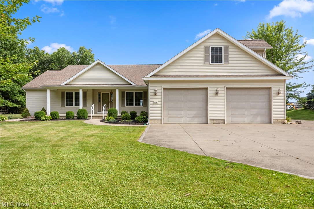 Welcome to 14617 Kneisel Road in desirable Vermilion Township! This spacious 3-bedroom, 3.5-bath home offers an exceptional blend of comfort, functionality, and entertaining space. The inviting floor plan features a formal dining room accented by decorative columns, a kitchen with a 9-foot granite island, granite countertops, backsplash, and an open great room filled with natural light and highlighted by a cozy fireplace.

The owner's suite features a walk-in closet and an ensuite bath featuring dual sinks. Two additional bedrooms are connected by a convenient Jack-and-Jill bathroom. Above the garage, you'll find a finished carpeted bonus area complete with office space, a bedroom or play area, and a full bath, providing flexible living options for guests, hobbies, or remote work.

Additional features include a laundry room with sink, cabinetry, and exterior access, a large 2.5-car attached garage, and a basement with additional crawlspace storage area. For added peace of mind, the home is equipped with a sump pump.

Step outside and enjoy the two-tiered wood deck overlooking the backyard. A standout feature of the property is the detached garage out back with an overhead door, electric, water, heat, and a covered side overhang, making it ideal for a workshop, storage, hobbies, or additional vehicle space.

Don't miss this opportunity to own a versatile property offering generous living space, quality finishes, and outstanding garage and workshop amenities in a desirable Vermilion Township location.