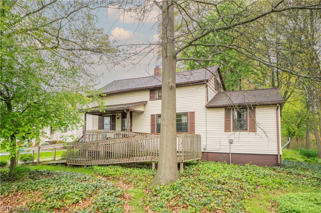 Private, cozy, and full of character, this move-in ready home is tucked away in a picturesque setting with a warm rustic feel throughout. The spacious living room features a charming stone backdrop for the wood stove and a unique log accent wall, creating an inviting space to relax and unwind. The generously sized primary bedroom is conveniently located on the first floor, while the upper level offers a large second bedroom and a roomy loft, perfect for a home office, study area, or quiet retreat. First-floor laundry and a full bathroom is located just steps from the kitchen for everyday convenience. Exterior highlights include vinyl siding with shake-style accents, attractive curb appeal, and a front entrance ramp for added accessibility.