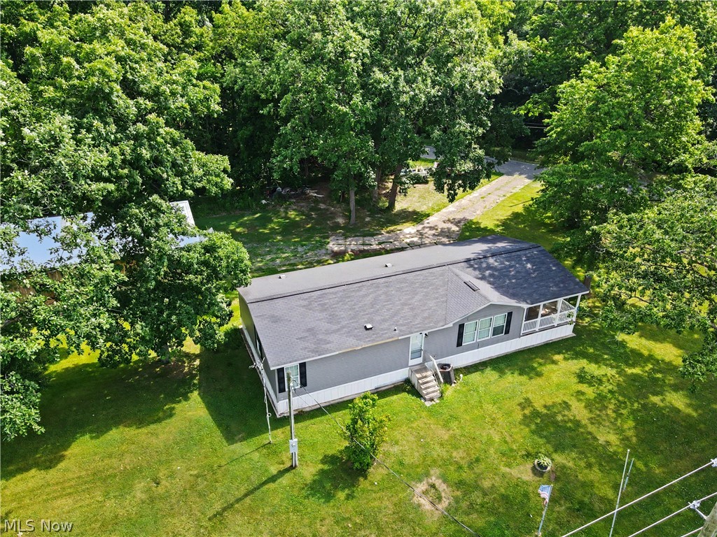 3424 Painesville Warren Rd Southington OH 44470 Trumbull County ~ Welcome to this easy, one-floor living, beautifully maintained home situated on a rural spacious 1.31 acre lot. Find a young 2018 move-in-ready home with 3 bedrooms & 2 full bathrooms on a level, gorgeous property with a huge outbuilding that can double as a garage with 2 large overhead doors & TRIPLE DEEP of typical garages 58'x28' for your many uses & hobbies. Don't miss out on this home that offers modern comfort, an open layout & the peaceful setting you've been searching for! Step inside to find a bright & inviting living room that flows seamlessly into the large kitchen & open dining area, creating the perfect space for everyday living & entertaining. Kitchen offers abundant cabinetry, ample counter space, & room for gathering with family & friends. Durable luxury vinyl flooring extends throughout the home, adding both style & easy maintenance. The oak dark cabinetry highlights the wonderful amount of storage in the kitchen & both of the bathrooms as well as the premium countertops with tile accent & stone facade on the kitchen island.
Thoughtfully designed floor plan includes 3 generously sized bedrooms & two full bathrooms, including a spacious primary suite with its own private primary bathroom. Convenient main-level laundry room provides additional functionality & storage.
Outside, enjoy the tranquility of country living from the welcoming front porch while taking in the view & surrounding property. The oversized lot offers plenty of room for outdoor activities, gardening, pets or future uses. With well & septic service, modern energy efficient construction & desirable location offering easy access to nearby communities, this property combines comfort, space & convenience. Whether you're looking for your first home, downsizing to one-floor living, or simply seeking a newer home on a peaceful setting, this property is ready to welcome you home. USDA Loan eligible, previous homestead exempt.