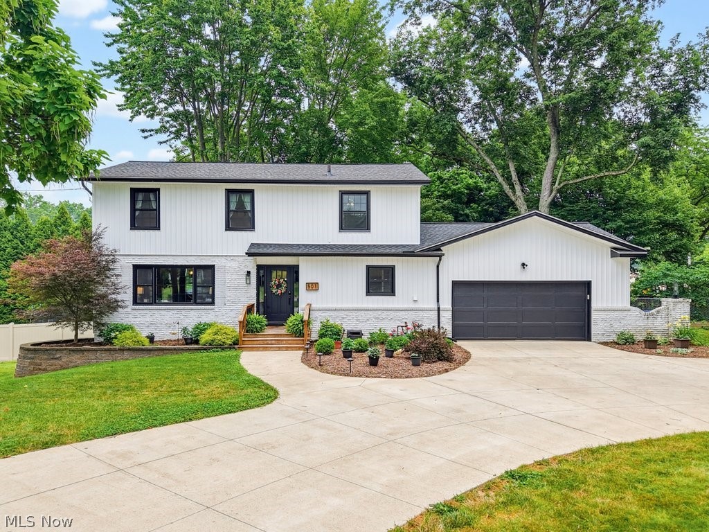 Welcome to this stunningly remodeled corner-Lot gem in a Prime Location! 501 Merriman Road has been beautifully transformed  and situated on a spacious double parcel, corner lot. 
From the moment you arrive, the incredible curb appeal catches your eye, featuring pristine landscaping and a masterfully crafted retaining wall. The brand-new siding and windows that provide energy efficiency and modern style.  

Step inside to find a completely reimagined interior ~ new luxury vinyl flooring throughout the 1st floor, complemented by custom woodwork, accent walls, and elegant built-in shelving. The entire home is illuminated by stylish new lighting fixtures and backed by a new electrical box.

The Kitchen has been completely remodeled with stainless appliances, granite countertops, tile backsplash, built-in cabinets and  pantry.
This home offers 4 bedrooms and 2.5 newly remodeled bathrooms.
The master suite features an abundance of storage with  three dedicated closets and a luxurious, brand-new master  bathroom (custom glass to be professionally installed prior to closing).
The first-floor half-bath doubles as a built-in laundry room, complete with a new washer and dryer, included in the sale!

The outdoor space is an entertainer's dream, with a lovely deck that overlooks a fully fenced-in yard.  Enjoy the fire pit under the ambiance of the included outdoor backyard lighting. Backyard play set stays with the property (trampoline does not convey).

SmartHome devices included:  Ring doorbell, smart thermostat, smart garage door opener and 2 smart switches. HWT 2023, Furnace/AC 2016, Roof 2016.

For buyer's peace of mind, this property is covered by a 1 year premium home warranty.

Located near Portage Country Club, Stan Hywet Hall & Gardens, shopping, parks, and a variety of dining options.

This turn-key masterpiece truly has it all. Schedule your private tour today.