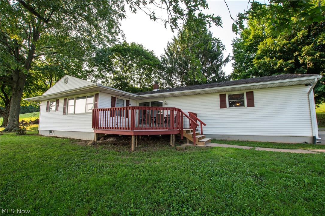 Beautifully Remodeled Ranch on 4 Scenic Acres! Welcome home to this beautifully updated ranch, sitting on  4 peaceful acres in a desirable country setting. Offering the perfect blend of modern updates and rural charm, this move-in-ready home provides comfortable one-level living with plenty of room to enjoy the outdoors. Step inside to find refinished hardwood floors (2023) that flow throughout much of the home, creating a warm and inviting atmosphere. The updated bathroom and refreshed lighting, including new ceiling fans and light fixtures (2019), complement the home's modern feel. The kitchen features newer appliances (2019), making meal preparation both stylish and convenient. Major mechanical updates provide peace of mind, including a new AC/heat pump (2022), water heater and water softener (2020), updated electrical outlets in select rooms (2019), and new smoke and carbon monoxide detectors (2020). The attached garage has also been improved with a brand-new garage door and opener (2025). Outdoor living is just as impressive with a spacious deck featuring added safety railing (2020), ideal for relaxing and taking in the beautiful countryside views. Pet owners will appreciate the invisible electric dog fence (installed in 2021) covering approximately 1–2 acres, giving furry family members plenty of room to roam. Whether you're looking for a peaceful country retreat, space for hobbies, or simply a move-in-ready home with extensive updates already completed, this property offers an exceptional opportunity. Enjoy the privacy of four acres while remaining just minutes from New Philadelphia's shopping, dining, and amenities. Don't miss your chance to own this beautifully maintained country property with modern updates and room to enjoy the outdoors!