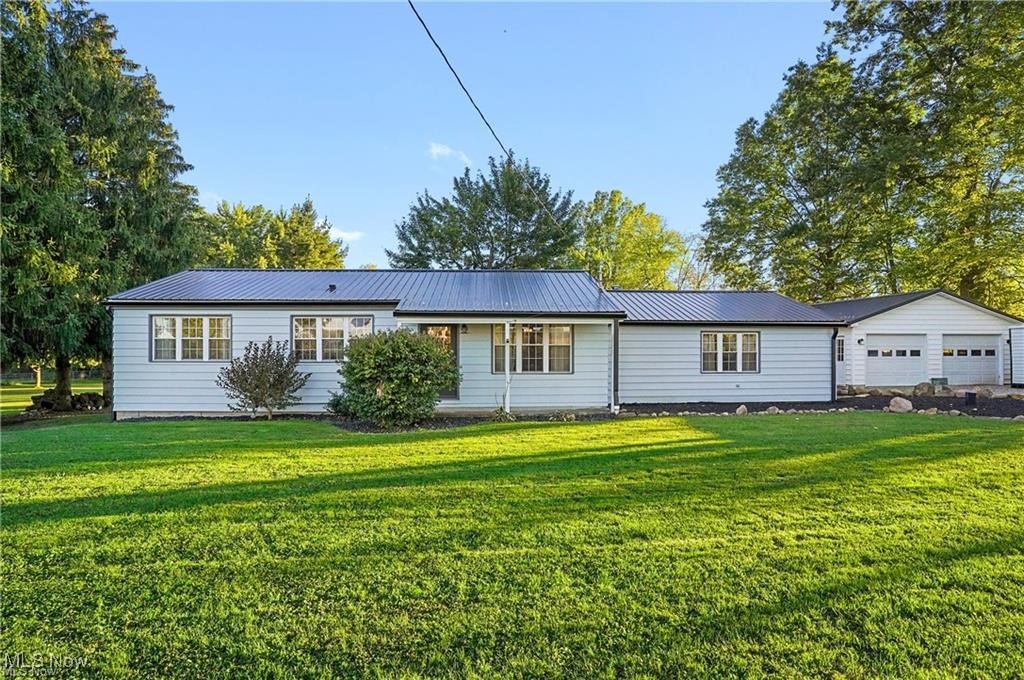 Ranch home built in 1964 featuring an oversized living room with a woodburner and access to rear deck. Fully updated eat-in kitchen with appliances, also having access to the rear deck. Two bedrooms, including a master with a recently updated full bath. There is a second full bath with laundry facilities located off the hallway. Modern washer and dryer stay with the home. Bonus room with front door access off the kitchen, unfinished basement with a block foundation, updated 200-amp breaker panel, modern forced-air gas furnace, and central air. The basement has been waterproofed at one time; other updates include a metal roof in 2023 with new gutters and replacement windows. The home has aluminum siding. Outbuildings include: a 24x32 detached 2-car garage with automatic overhead doors and a concrete floor, and a 24x24 building with a 10' overhead door, concrete floor, and fully insulated with an oil heat furnace. This would make a great workshop. 16x32 metal-sided storage shed with sliding doors. Well and septic. Situated on 1.6 acres in Goshen Twp., West Branch Local School District.