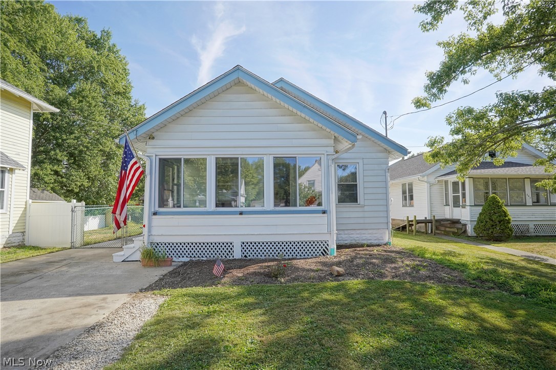 Check out this cozy home located in the heart of Ravenna. You are greeted by the sunroom that leads to the main living space with fresh brand new carpet. There is a formal dining room space off the living room which leads into an eat in kitchen with stainless steel appliances. Two bedrooms and full bathroom are located on the main floor. Downstairs, feature naturestone flooring with plenty of room for storage. Laundry room and bonus room which at one point was used as a music room. Large backyard with plenty of space. You will not want to miss this home. Features: new carpet in living and dining room, fresh paint in main living space, AC/Furnace new March 2020,  Water Tank 2016, Fridge and Range in 2018.
