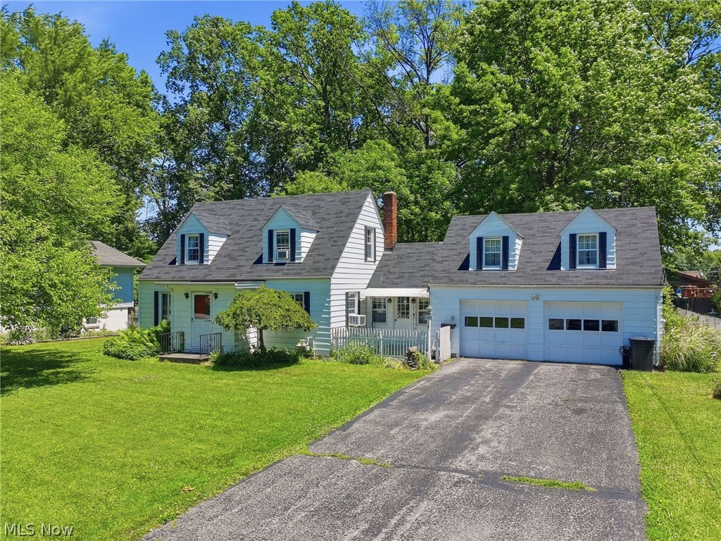 Charming, spacious, and full of character, this 4-bedroom, 2 full-bath home in the Mentor School District offers the perfect blend of timeless charm and modern updates. A bright and welcoming breezeway leads into the open kitchen, while the dining room features beautiful built-in cabinetry and abundant storage. The front entry opens to a warm and inviting living room showcasing the charm of both old and new. The main level includes a first-floor bedroom with a private one-person sauna and a beautifully remodeled full bathroom. Relax and unwind in the sunporch with screens and enclosures, offering peaceful views of the surrounding nature. Upstairs, you'll find two additional bedrooms and a cozy loft area, perfect for a reading nook, play space, home office, or flex area to fit your lifestyle. Off the attached 2-car garage, you'll find a utility room and a versatile fourth bedroom, office, or game room complete with its own full bathroom and enclosed porch, creating an ideal guest suite or private workspace. Beautiful new wood flooring flows throughout the home, enhancing its warmth and appeal. Outside, enjoy the fenced backyard featuring two storage sheds, a fire pit, and plenty of space for entertaining, gardening, or simply enjoying the outdoors. This unique property offers flexible living spaces, abundant character, and a welcoming setting with views of nature all around. A wonderful place to call home! A 1-year home warranty is included for added peace of mind.