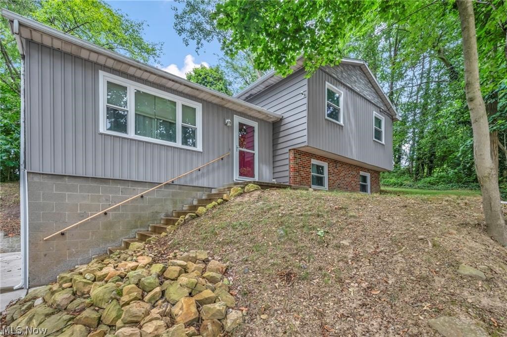 Welcome to 412 Stevenson Ave located in the beautiful Ellet neighborhood of Akron! Situated on a scenic lot offering a beautiful view & tons of privacy. In addition, this home offers a total of (4) parcels. This split-level gem features a spacious layout that includes a totally updated eat-in kitchen with new cabinets, countertops, flooring, lighting with all appliances included. The cozy & tastefully decorated living room & lower-level family room offers the perfect layout for everyday living & entertaining. (3) spacious second level bedrooms offer plenty of closet space & ceiling fans in each room. The large main bathroom has been updated with modern features, fixtures, flooring & double vanity sink. The lower-level laundry room is neat & organized & offers even more storage options. The (2) car side entry garage also has storage space & leads to a large private backyard with a deck & wooded rear view, ready for relaxing during our beautiful summer & fall nights. Additional updates include, electrical, roof 2024, all new windows (2025) entire home exterior vinyl siding (2025) interior & exterior of home freshly painted (2025) some updated gutters, updated hot water tank & furnace. The work has been done, this turnkey home is ready to move in & enjoy! Don't' miss the opportunity to call this home!
