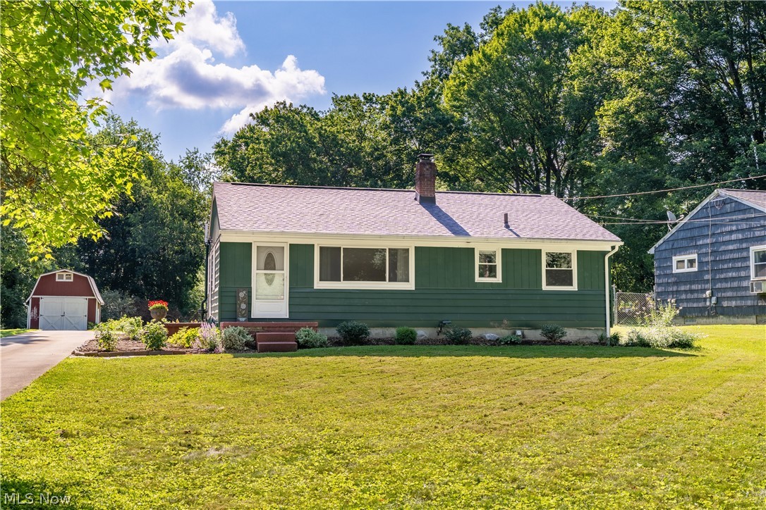 Lake Local Schools!! This three-bedroom ranch is tucked away on a quiet private lane in the desirable Lake Local School District and sits on a .47-acre lot offering a peaceful setting with room to enjoy the outdoors. The home features hardwood floors, tilt-in windows, and a bright living room with recessed lighting and a large picture window that fills the space with natural light. The eat-in kitchen offers white cabinetry, newer kitchen appliances, and a dining area overlooking the backyard. The main level includes three bedrooms, a full bath, and convenient built-in hallway storage. The partially finished basement provides additional living and functional space including a rec room, office area, laundry area, and stairs providing access to both the main level of the home and a over-sized attached two-car garage with access to the basement. Outside you’ll find a partially fenced yard, mature landscaping, raspberry and dewberry bushes, and a storage shed for tools and equipment. Recent improvements include newer kitchen appliances, newer roof and gutters, high-efficiency oil furnace, updated electrical panel, fresh interior and exterior paint, and a radon mitigation system already installed. Great opportunity to purchase a solid ranch home in Lake Local Schools with a quiet private setting.