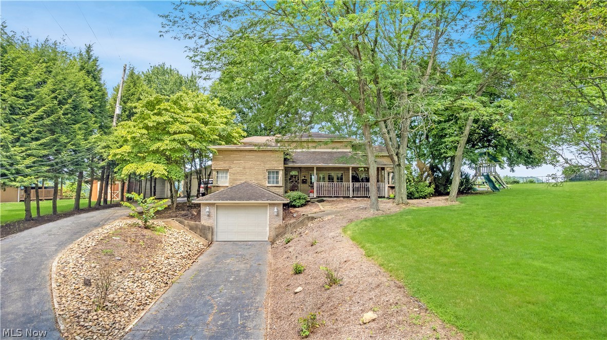 Perched atop one of Weirton's most desirable hilltop settings, this exceptional home offers privacy, beautiful surroundings, and stunning Ohio River views that make this location so highly sought after. Offering over 3,000 square feet of living space, this 3-bedroom, 2.5-bath home features generous room sizes, multiple gathering areas, and a comfortable layout designed for everyday living and entertaining. The spacious kitchen and dining area are filled with natural light, creating a warm and inviting space for family meals and gatherings. The spacious primary suite features a private ensuite bath and a large picture window that fills the room with natural light while overlooking the peaceful backyard and the Ohio River beyond. Step outside to the expansive rear deck, the perfect place to enjoy your morning coffee, entertain guests, or simply relax while taking in the beauty of this elevated setting. An attached one-car garage and detached two-car garage provide added convenience. Conveniently located just minutes from shopping, dining, schools, and everyday amenities, this is a rare opportunity to own a home in one of the area's most desirable locations. Call an agent today for a private showing.