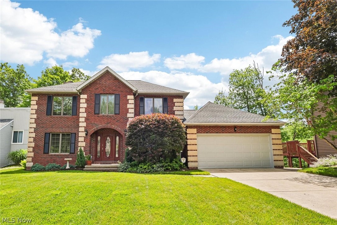 Welcome to this beautifully maintained 3,258 SF home offering the perfect blend of timeless elegance, quality craftsmanship and modern efficiency. Featuring 3 bedrooms, 2.5 baths and a dedicated home office, this impressive residence sits on a scenic lot overlooking a serene wooded valley. Built with solid brick on all 4 sides, the home delivers exceptional durability, energy efficiency and outstanding curb appeal. Inside, you'll find solid wood doors, rich red oak stained poplar crown molding and detailed trim throughout. The spacious living room features a cozy wood burning fireplace, refreshed in 2025 with new carpeting and a modern paint palette. The updated kitchen boasts premium granite tops, oak flooring, LED lighting and upgraded appliances, creating a stylish and functional gathering space. The luxurious primary bath serves as a private retreat with travertine, slate, and granite finishes, radiant heated floors, updated lighting and a chair height toilet. A 2nd full bath offers granite countertops and custom tile flooring. Designed for year round comfort, the home features Andersen casement windows with built in insect screens, custom window treatments, upgraded R15 wall insulation and R35 ceiling insulation. The finished walkout basement provides expansive living and entertaining space with insulated walls, a full bar with dry sink and dedicated 240V powered baseboard heating. The 2 car garage offers mudroom access, EV charger ready 240V service, attic storage with a temperature controlled vent fan, newer 30 plus year roof, updated water heater and a built in security system. Outdoor living is enhanced by a large walkout deck with a beautifully landscaped yard and sprinkler system. Located in Brecksville, this home is served by the award winning Brecksville Broadview Heights Schools. Enjoy easy access to downtown Brecksville, recreation center, Metro Parks and highways, offering the perfect balance of privacy, convenience and exceptional quality of life.