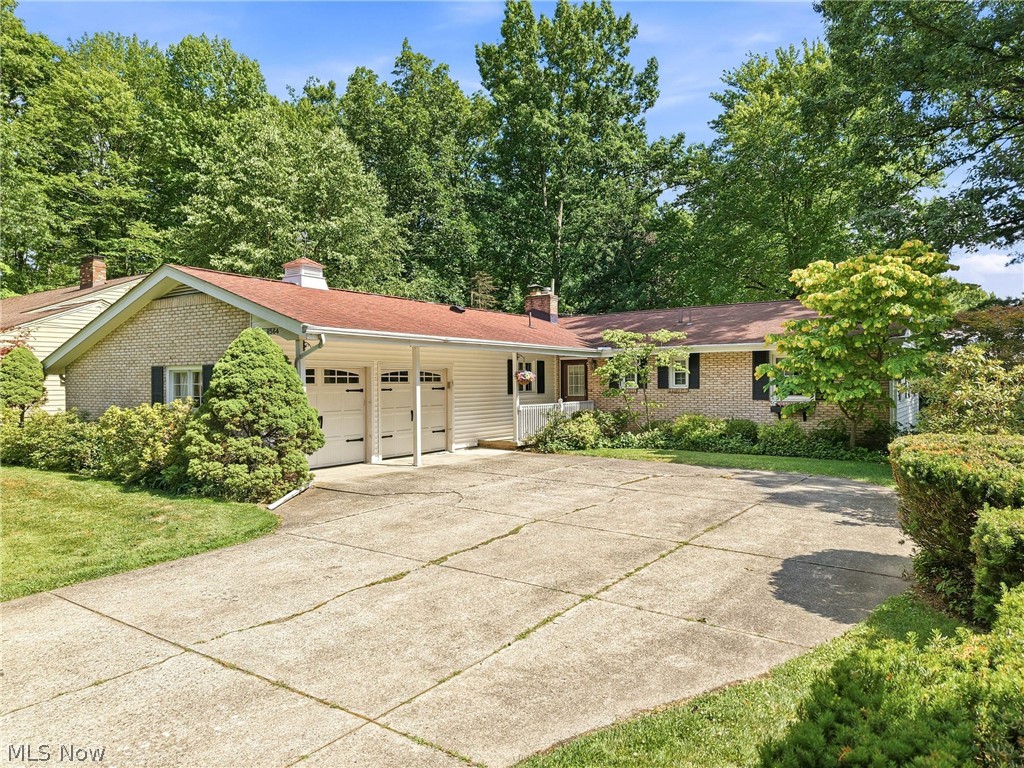 Welcome home to this well-maintained 3-bedroom, 3-bath ranch located in the desirable Howland School District. Offering comfortable one-floor living and plenty of additional space, this home has been lovingly cared for throughout the years and is ready for its next owner. Step inside to find a spacious living room with a fireplace and adjoining dining area, creating a welcoming space for both everyday living and entertaining. The kitchen has been updated with solid wood cabinetry, solid surface countertops, a fiberglass backsplash, laminate flooring, a pantry, and a granite-topped center island that serves as an ideal prep station. An eat-in area provides additional dining space, while the adjoining den offers a cozy retreat with access to the enclosed porch overlooking the private backyard. The main level features three bedrooms, including a primary suite with its own full bathroom complete with a walk-in shower, tile walls, and tile flooring. A second full bathroom offers a porcelain tub with tile surround and a large vanity. The waterproofed basement provides exceptional flexibility with a large recreation area, laundry space, abundant storage, and an additional room with a closet that could be used as a guest room, office, workout space, or hobby room. An attached two-car garage adds convenience and extra storage. Enjoy the privacy of the backyard while being conveniently located near shopping, dining, parks, and major roadways. Combining space, functionality, and a highly sought-after location, this Howland ranch is one you won't want to miss.