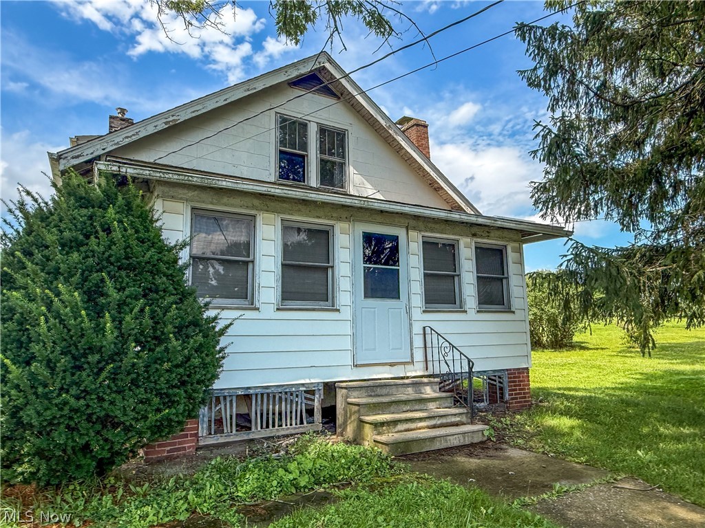 Located on an extra large lot with acreage, 10595 Forty Corners offers a rare opportunity for buyers looking for space, functionality, and long term potential. This 3 bedroom, 1 bathroom home features original hardwood flooring, a spacious kitchen, and a three season front porch that adds additional living space and a welcoming entry to the home. The property will require TLC and is ideal for buyers ready to renovate and build equity.

Outside is where this property truly stands out. A large, newer garage outbuilding with tall ceilings and double garage doors provides excellent space for vehicles, equipment, or workshop use. Additional outbuildings include a horse barn and chicken coop, both in need of repair but offering great potential for hobby farming or storage.

The home is serviced by propane heat, a private well, and a septic system, with both the septic and furnace being newer major improvements. With generous acreage, multiple outbuildings, and room to grow, this property presents a unique opportunity for buyers seeking land, flexibility, and future potential.