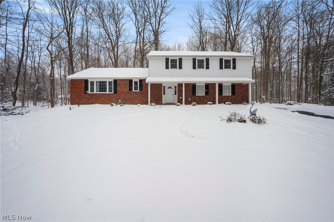 Set on 1.61 wooded acres in Bainbridge's sought-after Pilgrim Village, this beautifully updated Colonial offers space, privacy, & access to exceptional community amenities. Located in the Kenston School District & situated on one of the larger lots in the neighborhood, the property provides a serene setting surrounded by mature trees while remaining part of a vibrant lake community whose residents enjoy access to Lake Taylor, w/ a sandy beach, swimming, fishing, kayaking, paddleboarding, volleyball, BBQ area & a covered pavilion. With 2,400 sq ft, 4 bedrooms & 2.5 baths, the home features flexible living spaces designed for everyday comfort & entertaining. An updated eat-in kitchen features quartz countertops, stainless steel appliances & a dinette area. A family room w/ brick fireplace & access to a back patio & expansive backyard creates easy indoor-outdoor flow. A welcoming living room w/ a large picture window opens to a formal dining room w/ built-in cabinetry, and a spacious 1st-floor laundry & mud room and attached 2-car garage add convenience & functionality. The primary suite includes an en-suite bath w/ a walk-in shower, and 3 additional bedrooms plus a versatile bonus room provide options for a home office, playroom, or additional lounge space. A partial basement offers excellent storage & potential for future finishing.  Recent updates include: Replaced boiler (2025), washer/dryer (2023), installed buffet cabinets in dining room (2025), gutter guards (2025), replaced rear 2nd story gutters, sub-fascia & added larger soffits (2025), added fiberglass insulation batts in attic (2025), removed 7 large trees close to house (2024), painted master bed/bathroom & guest bedroom (2024), and more! INCLUDED are ALL kitchen appliances, washer/dryer, window A/C units, Ring doorbell, TV mounts, and all window treatments. Conveniently located near US-422, OH 306, shopping, restaurants, schools, parks, and other local attractions. A must see!