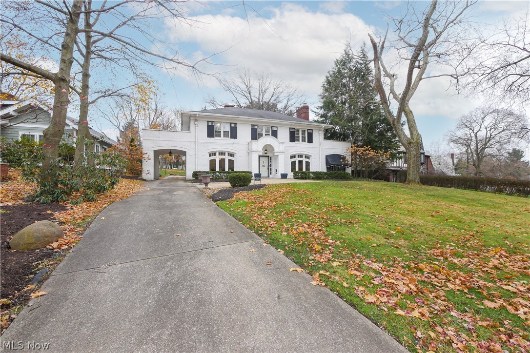 Welcome home to 1173 Sunset View Drive. This classic all brick center hall 2 story home was designed by Roy Firestone himself and is on one of the most beautiful streets in Akron. From a marble floored vestibule to the foyer with a grand staircase, this home has all of its original charm while maintained and updated beautifully. The great room with a gas log fireplace, french doors on both sides of the fireplace which lead to a screened in sun porch with sliding doors to the patio and in ground pool. The formal dining room with 2 sets of French doors is perfect for hosting a dinner party. The updated white kitchen with stainless steel appliances, center island, granite counters, breakfast eating area with a built-in china cabinet. 1/2 bath completes 1st floor. The second floor has a owner's suite with two pedestal sinks and an attached 13 X 11 wardrobe room with dressing island. The second and third bedrooms have a Jack and Jill bath. Back wing has 4th bedroom, a huge second floor laundry room and an additional full bath, hall walk in cedar closet plus 2nd back staircase. The lower level has a large paneled rec room with a stone fireplace and gas logs. Wine room/cellar with stone walls and porcelain floor as well as a large workout room and a toilet room attached. There is so much storage space in the basement as well. This home truly has it all! From the beautiful updates to the original hardwood floors and charm - you won't want to let this one go!