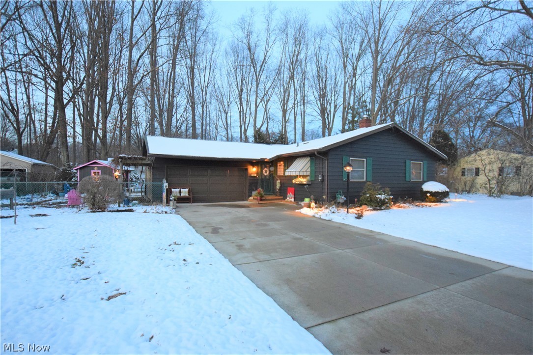 Three bedroom, two bathroom ranch in Munroe Falls with two-car attached garage! Eat-in kitchen has updated laminate wood flooring, white cabinets, and gorgeous countertops. New vintage-style stove, fridge and dishwasher -- super cute and unique! Living room is spacious with hardwood floors and a wood burning stove. Large sunroom off the living room leading to a covered patio. Bedrooms have hardwood floors. Beautifully landscaped with blueberry bushes, currant bushes, and rhubarb!   Covered outside patio with grill!  Back yard also has a new privacy fence along one side and storage shed.  The 4 seasons room boasts a new heater and air conditioner unit.  Lots of updates on this one, move in ready! No worries as this also comes with America's Preferred Home Warranty.